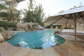 TROPICAL BACK YARD SWIMMING POOL COUNTER AND BAR STOOL IN POOL, WATERFALL VIEW