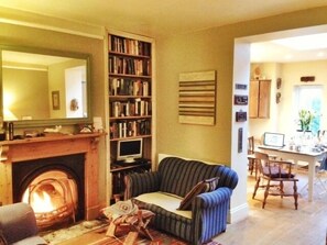 The cosy living room opens out into the light dining area and kitchen