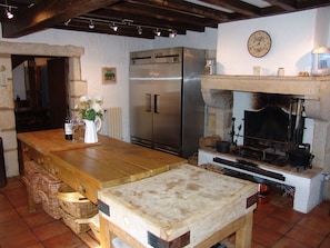 Kitchen - commercial stainless steel fridge/freezer. Beautiful stone fireplace.