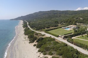 Aerial view of the villa, set between sea and olive groves  