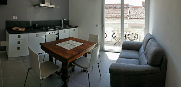 wide living and kitchen room with sofa and balcony (air conditioning)
