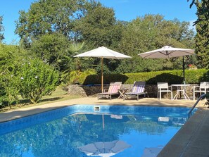 Pool area surrounded by flowering shrubs