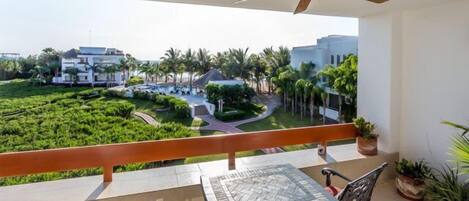 The balcony, looking east, overlooks the ocean, beach, and one of the two pools