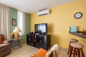 The entertainment center has a 42 inch TV, the WiFi router, and a DVD player