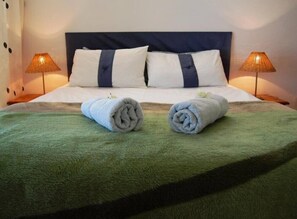 Main bedroom with queen bed and balcony. 