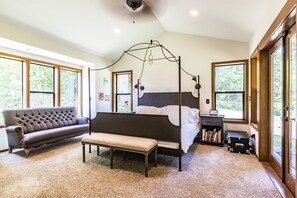 Master bedroom with king size bed and a private deck