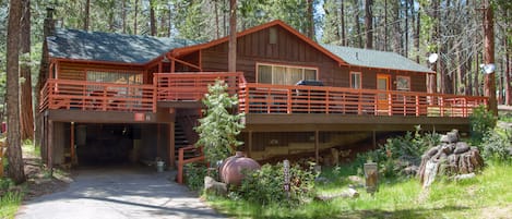 Front of the cabin with a carport