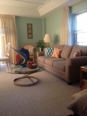 living room w/ new carpeting, new furniture and freshly painted.