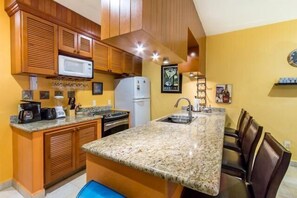 The fully equipped kitchen has everything you might: small and large appliances, lots of glassware and cooking stuff, and basic ingredients