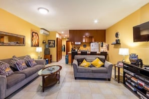 The long common area has two comfortable couches, a flat screen TV, lots of movies and games, and a fully equipped kitchen