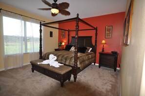 Master bedroom King size 4 poster bed African themed room. Walk out to Pool Deck