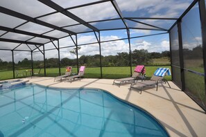 Large screened patio with pool and and plenty of space to lounge and relax.