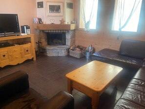Open plan living area with comfortable seating and fireplace