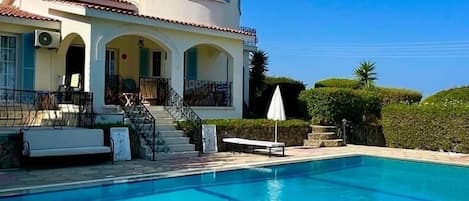 The pool area and back of the villa, looking towards the pool terrace