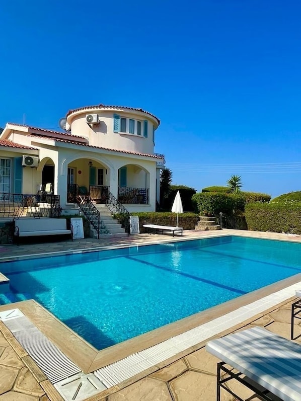 The pool area and back of the villa, looking towards the pool terrace