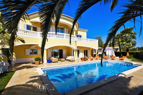 front of villa and pool from palm