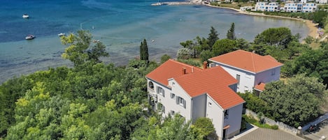 House and sandy beach behind