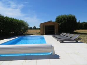 The south facing pool terrace with luxury rattan reclining sun loungers and WiFi