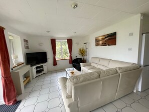 a open living room with a large smart TV, free wifi , plenty of room for all .