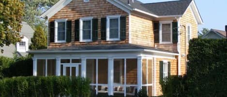 The front of the house with a screened-in porch
 