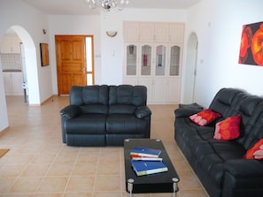 Spacious lounge area with aircon, satellite TV, and direct access to patio