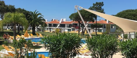 Heated circular pool with apartment in the background