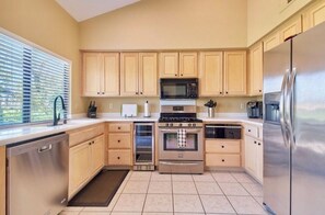 Well stocked kitchen with stainless steel appliances. 