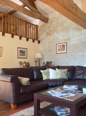 The double height beamed lounge with mezzanine level above.