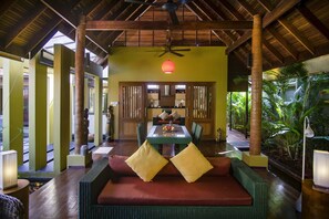 Open-plan Balinese/Thai-style living area with natural wood elements 