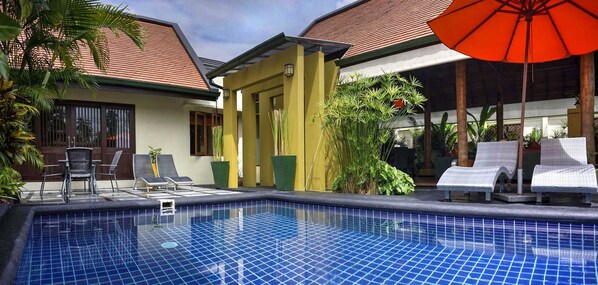 Saltwater pool with sun loungers and outdoor seating area