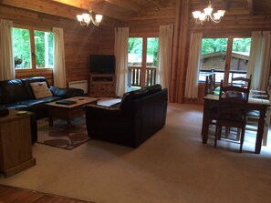 Carpeted lounge area with corner and 2 seater settee 