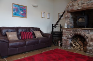 Comfy sofas and wood burning stove in the lioving area
