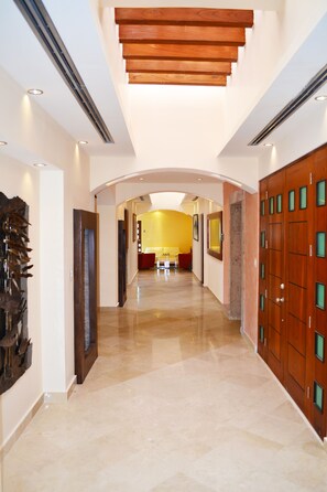 Hallway leading to bedrooms and patios