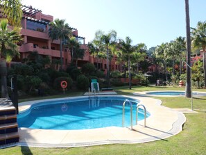 The apartment block and the nearest pool
