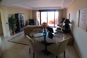 The living room and dining area has patio doors to the terrace with sea views