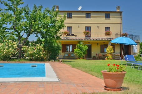 A 4 bedroom house with a private garden with a pool & parking area