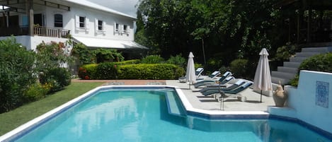 The superb sun drenched pool area with the villa in the background. Paradise .