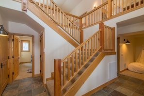Staircase up to main level with kitchen, living and dining areas.