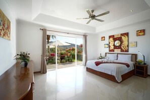 Bedroom 1 with a king-size bed, air conditioning and en-suite bathroom.