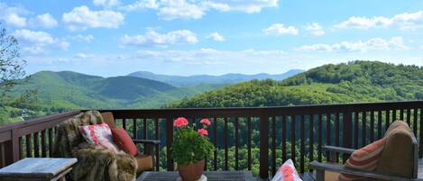 The outdoor living room has an expansive view of the surrounding mountains.