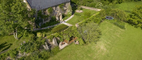 The main garden showing the fire-pit and outside dining area under the vines.