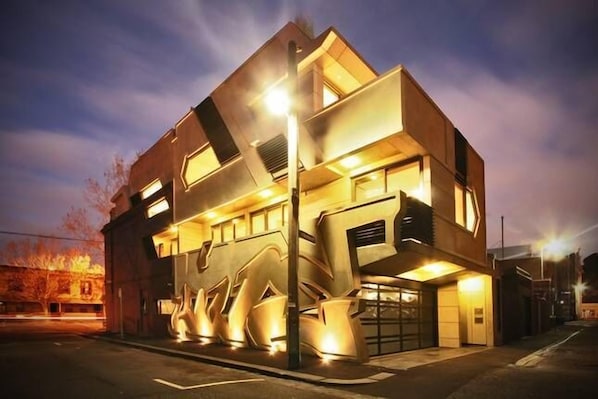 external night view of whole apartment building (containing all three apartments