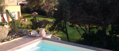 a view of the pool, the garden and the house