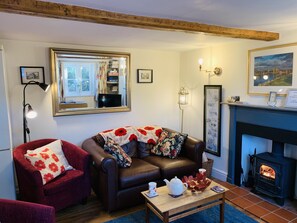 Relax in front of the log burning stove with a cup of tea after a day walking