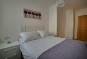 Beautiful bedroom with double bed and fitted wardrobes.