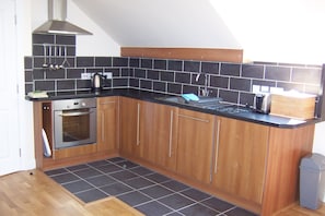 Well equipped and stylish kitchen with dishwasher & fridge freezer, oven & hob.