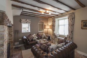 Cosy living room with large inglenook fireplace, 48” TV, AppleTV and Bose