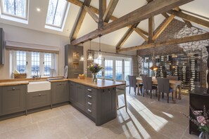 Spacious, fully equipped open plan kitchen with dining area and bi-folding doors