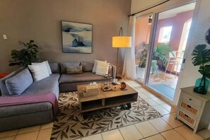 Living room with a cozy sofa and access to the balcony