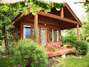 Cottage is surrounded by apple trees, berries, grape vines & flowers.